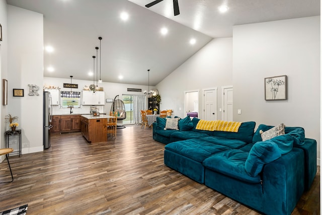 living room with high vaulted ceiling, dark hardwood / wood-style floors, and ceiling fan