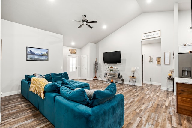 living room featuring ceiling fan, dark hardwood / wood-style floors, and high vaulted ceiling