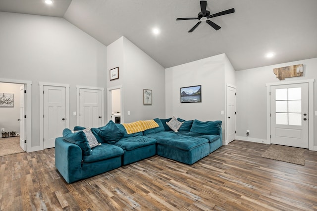 living room featuring ceiling fan, dark hardwood / wood-style floors, and high vaulted ceiling