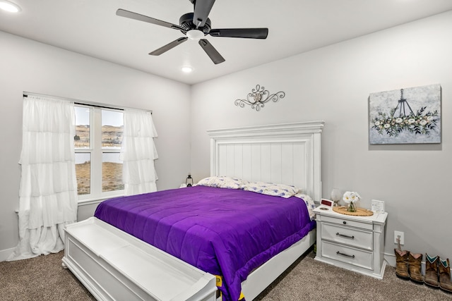 bedroom with ceiling fan and dark carpet