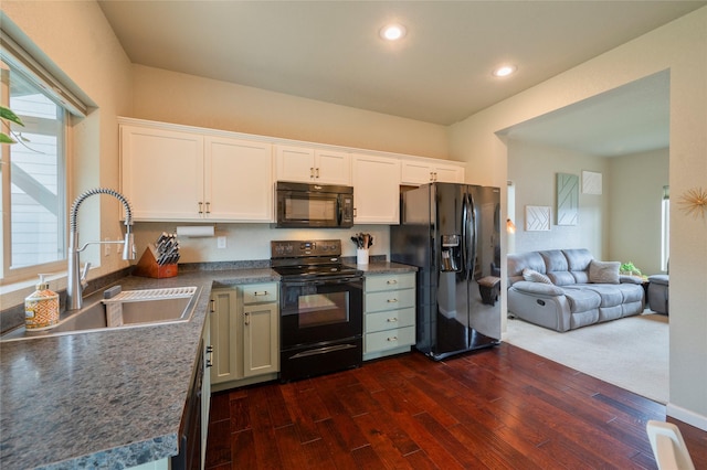 kitchen featuring dark wood-type flooring, sink, black appliances, kitchen peninsula, and white cabinets