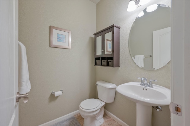 bathroom featuring sink, tile patterned floors, and toilet