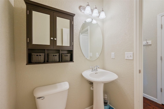 bathroom featuring hardwood / wood-style floors and toilet