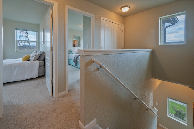 hallway with light colored carpet