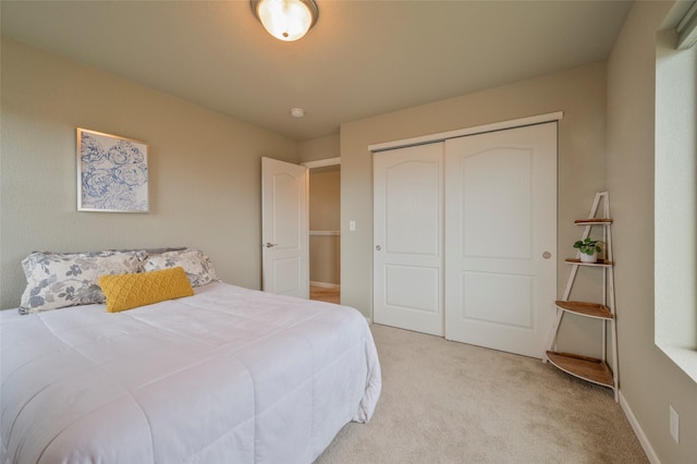 bedroom featuring light colored carpet and a closet