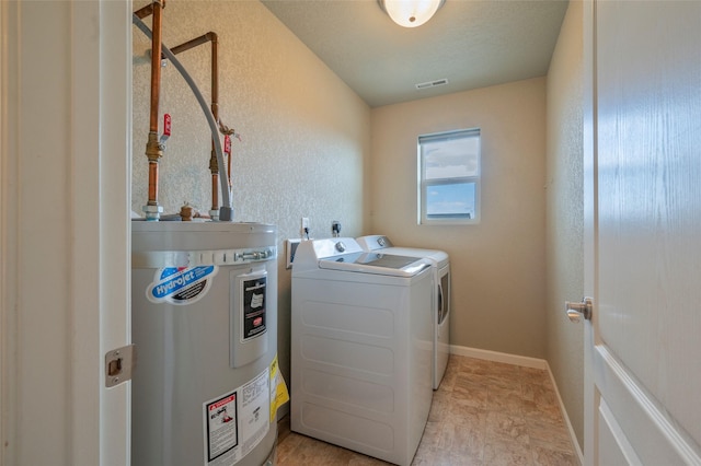 washroom with independent washer and dryer and electric water heater