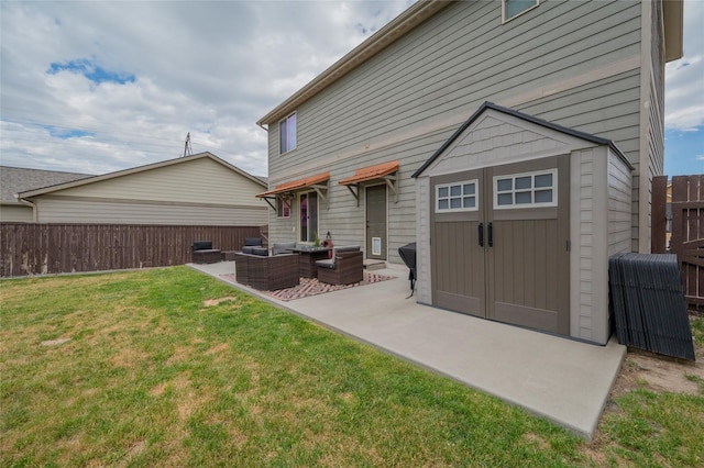 back of house featuring a storage shed, outdoor lounge area, a yard, and a patio area