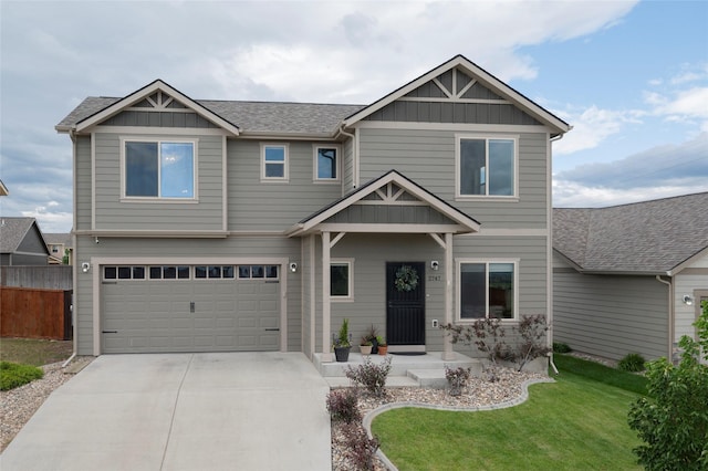 craftsman-style house featuring a garage and a front lawn