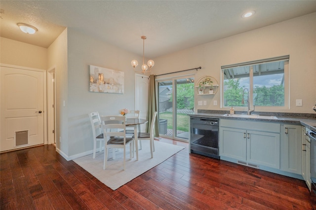 kitchen featuring pendant lighting, sink, black dishwasher, a notable chandelier, and dark hardwood / wood-style flooring