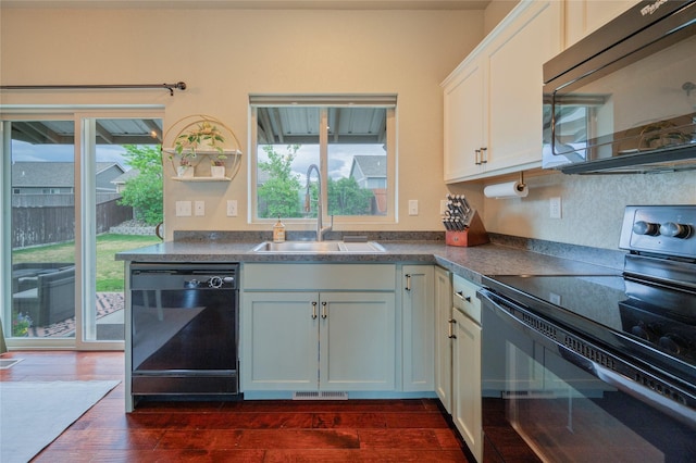 kitchen with sink, black appliances, dark hardwood / wood-style floors, and white cabinets