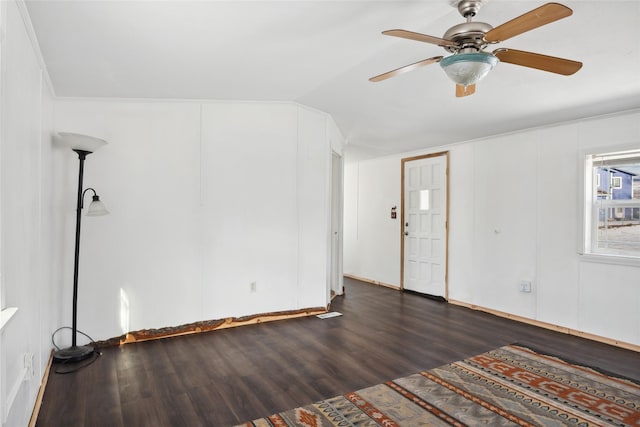 empty room featuring lofted ceiling, dark wood-type flooring, and ceiling fan