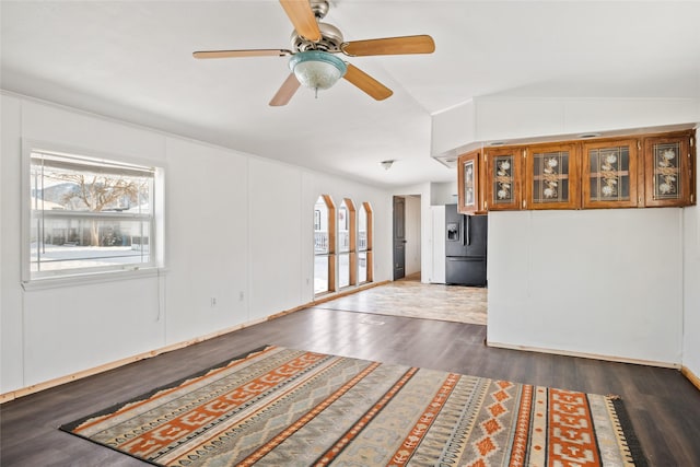 unfurnished room with dark wood-type flooring, ceiling fan, and lofted ceiling