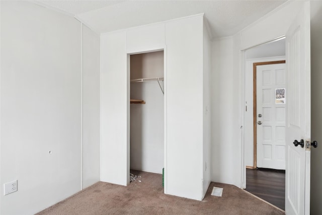 unfurnished bedroom with a closet and carpet