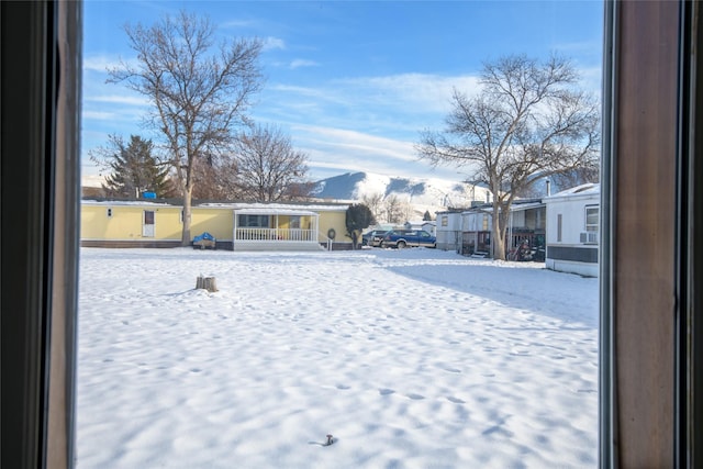 yard covered in snow with a mountain view