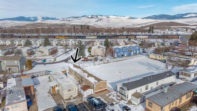 snowy aerial view with a mountain view