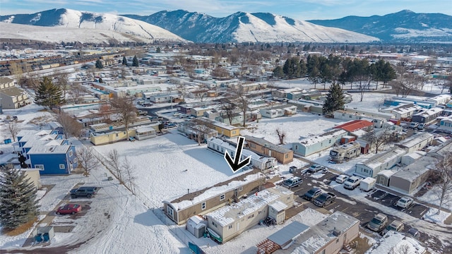 snowy aerial view with a mountain view