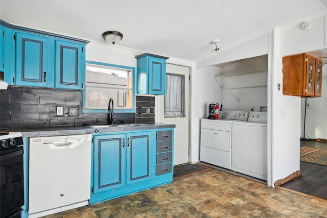 kitchen featuring sink, blue cabinetry, stove, washing machine and dryer, and white dishwasher