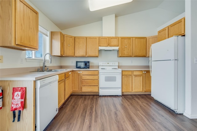 kitchen featuring vaulted ceiling, dark hardwood / wood-style floors, light brown cabinetry, sink, and white appliances