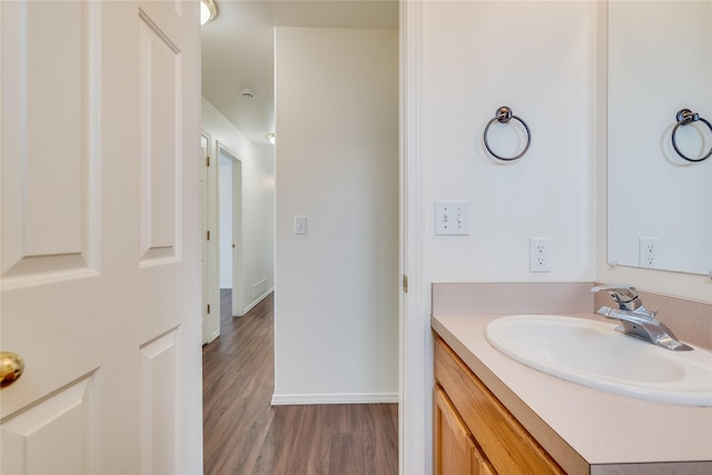 bathroom with hardwood / wood-style flooring and vanity