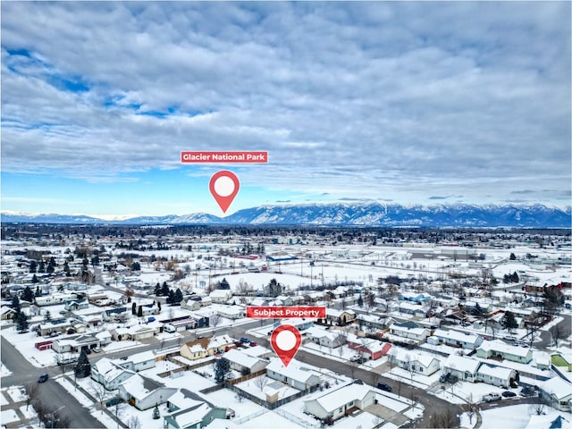 snowy aerial view featuring a mountain view