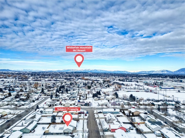 snowy aerial view featuring a mountain view