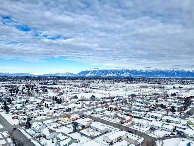 snowy aerial view with a mountain view