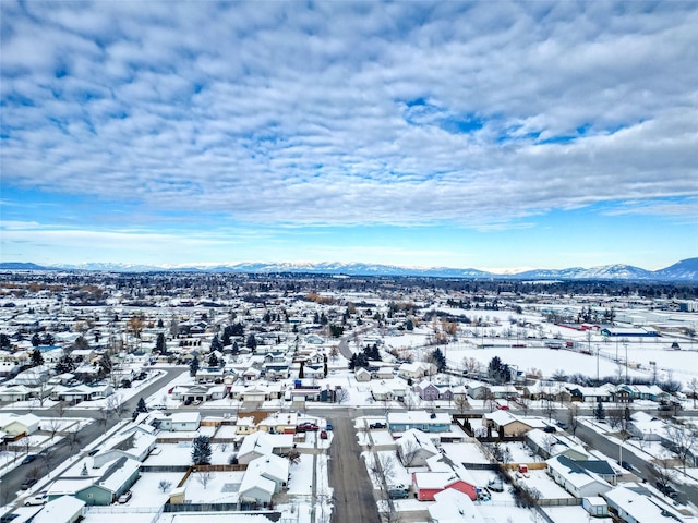 snowy aerial view featuring a mountain view