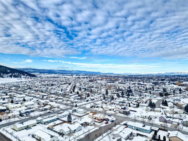 snowy aerial view with a mountain view