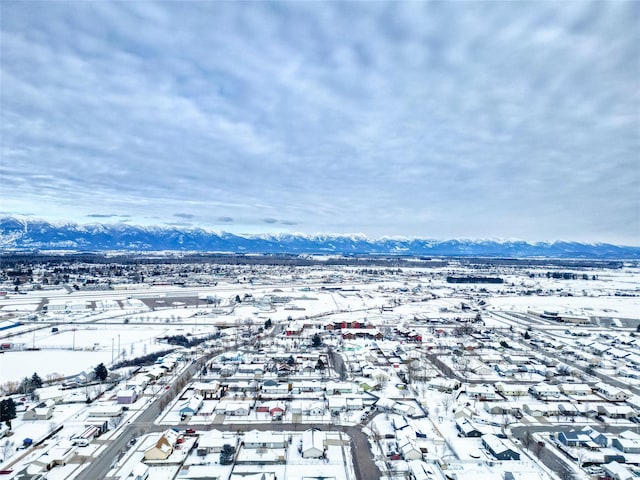 snowy aerial view featuring a mountain view