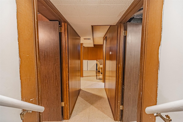 corridor featuring wood walls