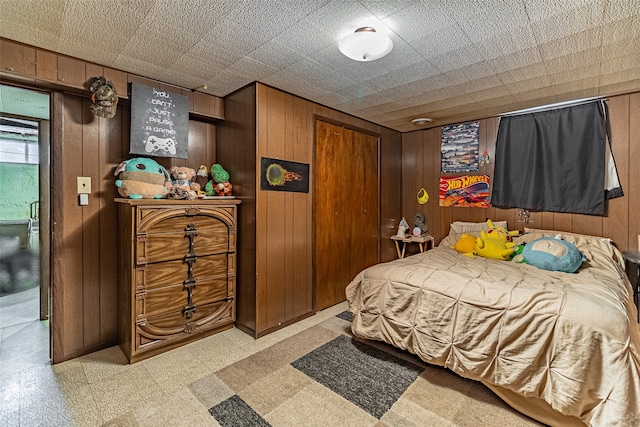 bedroom featuring wooden walls