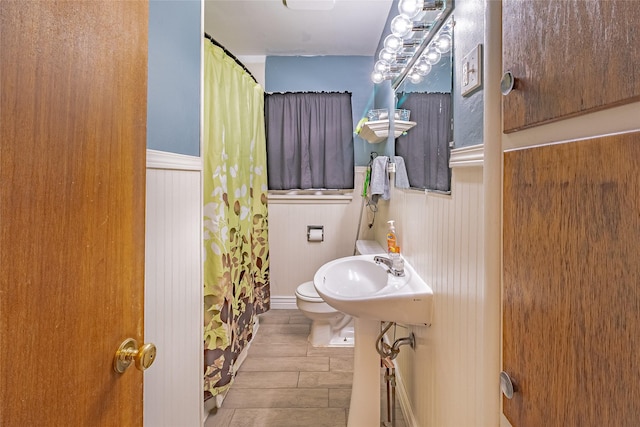 bathroom with hardwood / wood-style flooring and toilet