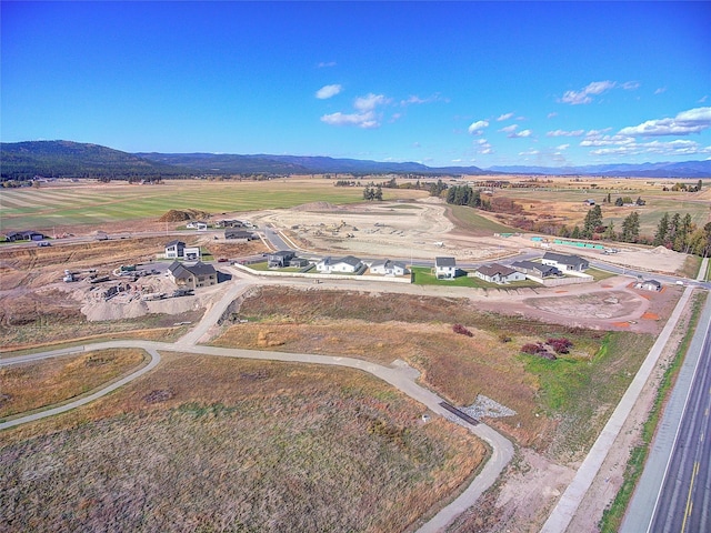 drone / aerial view featuring a mountain view and a rural view