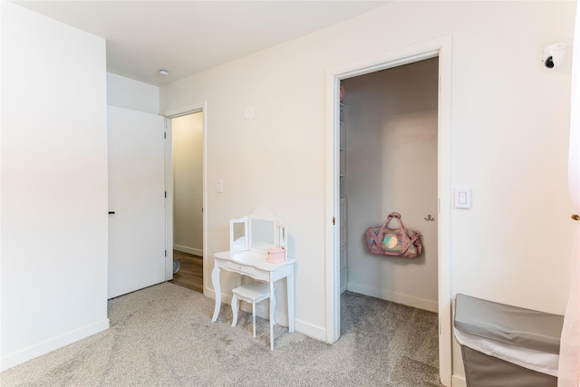 interior space featuring a walk in closet and baseboards