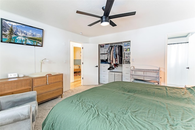 bedroom featuring light colored carpet and ceiling fan