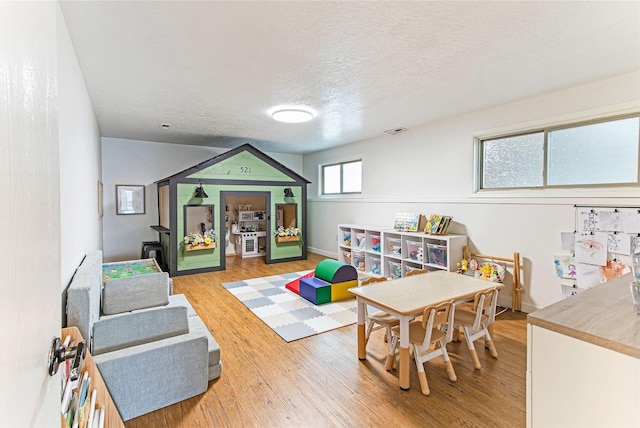 137 Cascade St, Lolo, MT 59847 - game room featuring light wood-type flooring, a textured ceiling, and baseboards
