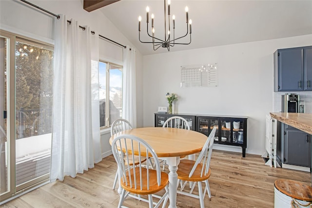 dining room with an inviting chandelier, vaulted ceiling with beams, and light hardwood / wood-style flooring