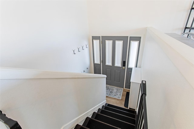 stairway with wood finished floors