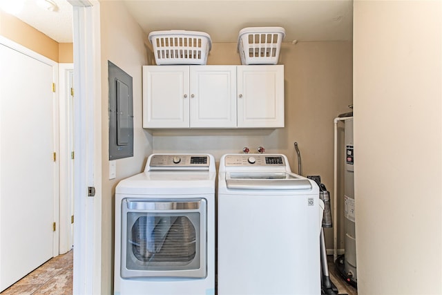 laundry area featuring washing machine and dryer, cabinet space, and electric panel