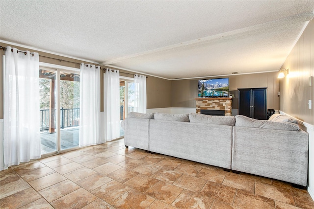137 Cascade St, Lolo, MT 59847 - living area featuring a textured ceiling, a fireplace, and stone finish floors