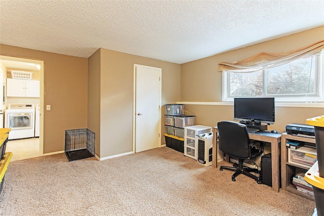 carpeted home office featuring a textured ceiling, washer / dryer, and baseboards