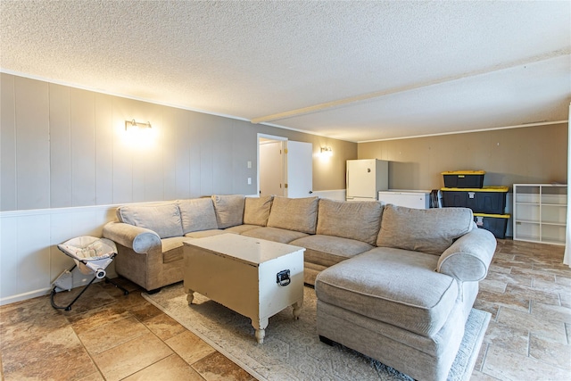 living room featuring a textured ceiling and stone tile floors