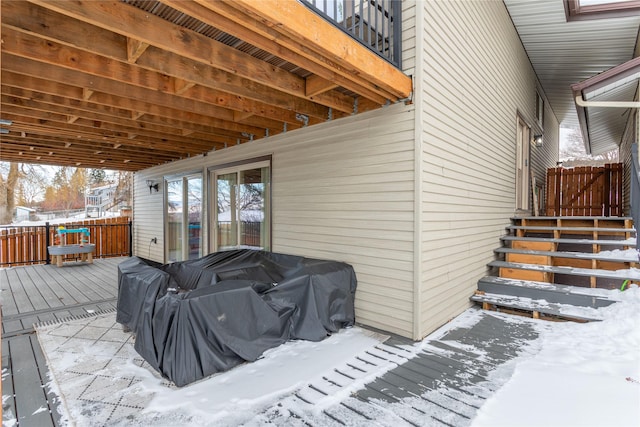 snow covered deck with fence