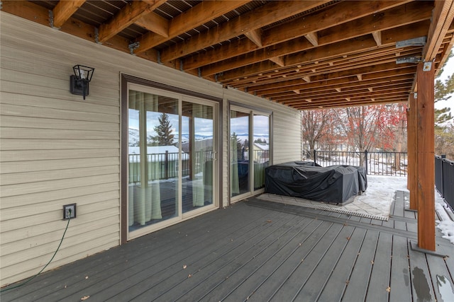 snow covered deck featuring a grill