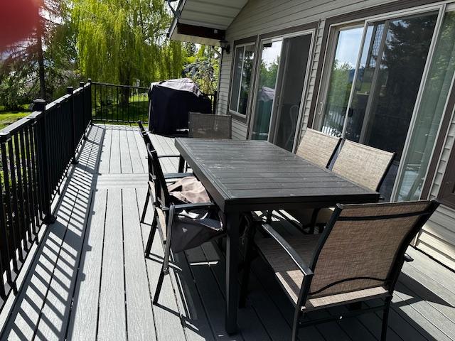 137 Cascade St, Lolo, MT 59847 - wooden deck with outdoor dining space