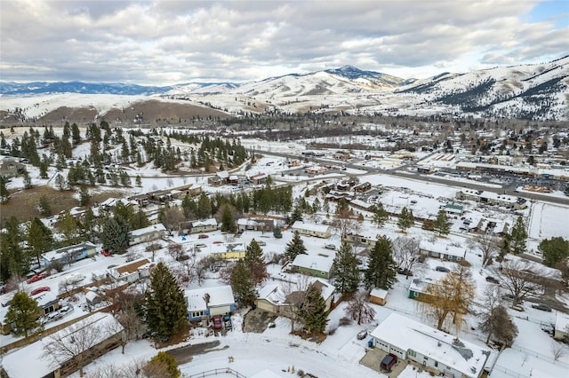 snowy aerial view featuring a mountain view