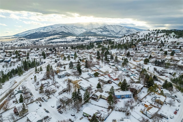 snowy aerial view with a residential view and a mountain view