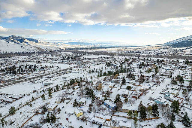 snowy aerial view featuring a mountain view