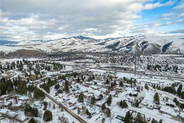 snowy aerial view with a mountain view