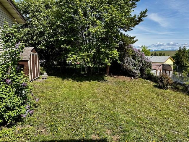 137 Cascade St, Lolo, MT 59847 - view of yard with a storage unit and an outbuilding
